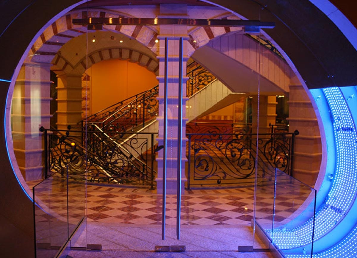nvision Glass Custom circular glass entrance with illuminated architectural design